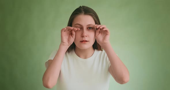 Worried Woman Wipes Tears By Hands Posing for Camera alt