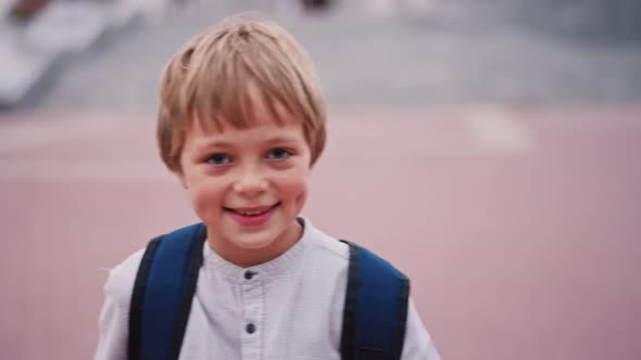 Portrait of 8 Year Caucasian Boy Looking to the Camera and Smile with Dimples on Cheeks alt