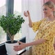 Pregnant Woman Caring for Houseplant - VideoHive Item for Sale