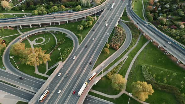 Aerial Flyover Car Traffic Roundabout Interchange Road in Evening Drone Shot Top Down Roadway alt
