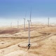 Epic View of Working Windturbines Located on the Golden Hills Under the Blue Sky - VideoHive Item for Sale