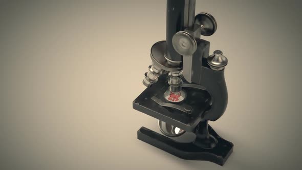 A vintage microscope used to study and analyze microbes, bacteria and cells.