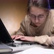 A young woman&#39;s old laptop starts to smoke while she is working - VideoHive Item for Sale