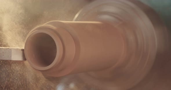 Man working on a wood lathe creating art - slow motion macro shot alt