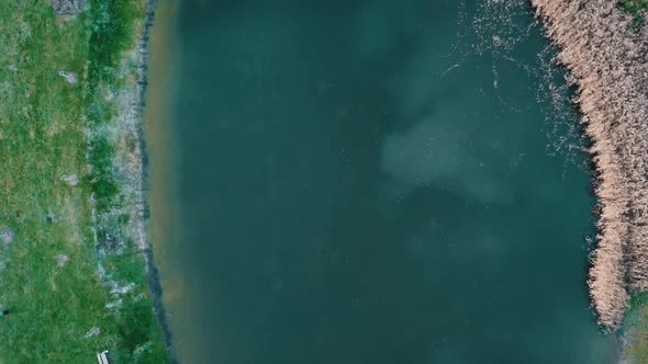 Blue Water In Pond During Fall Near Town In South Moravian Region, Czech Republic. - aerial, top dow alt