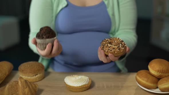 Overweight Girl Holding Muffin and Donut, Overeating Sugar, Risk of Diabetes alt