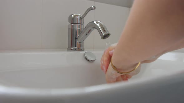 Female Hands Closeup Washing in Home Bathroom Full of Daylight