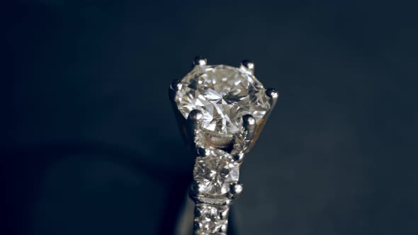 Extreme detailed of diamond ring close up shot while rotating on dark background alt
