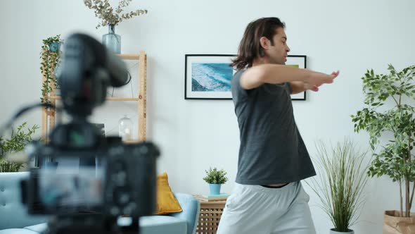 Mixed Race Man Vlogger Recording Sports Tutorial Then Showing Thumbsup Hand Gesture alt