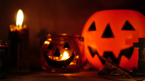 The concept of the Halloween festival with the orange pumpkin, candle light, and the bone skull alt