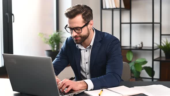 Successful Bearded Young Businessman at Workplace alt