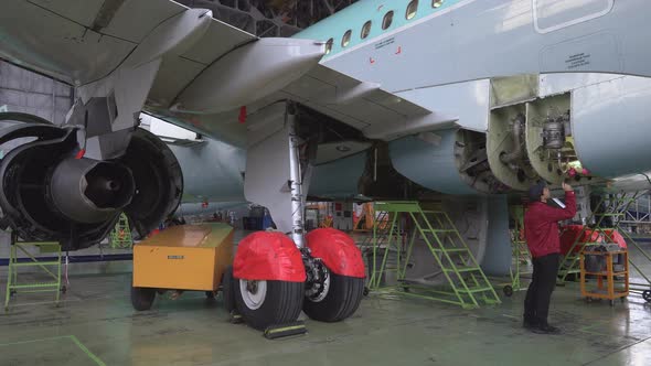 Engineer technician inspects the inside of the aircraft with a flashlight