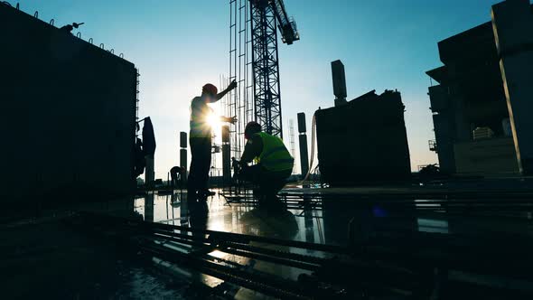 People in Uniform Work at a Construction Site. alt