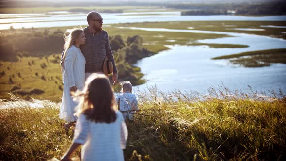 A Little Girl Running To Her Family on the Wheat Field alt
