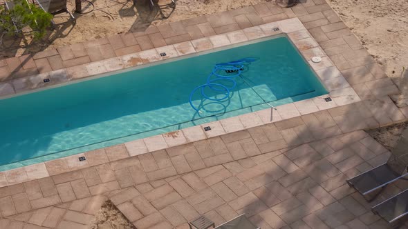 Service and Maintenance of the Swimming Pool in a Hotel on Sunny Day