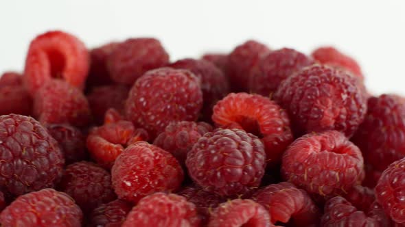 Eco bright colorful berry raspberry rotates 360 on a white background. Close-up of loose raspberry