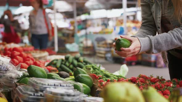 Young Attractive Woman Choosing Organic Fruits and Vegatables at Farmer's Market Close Up Shot alt