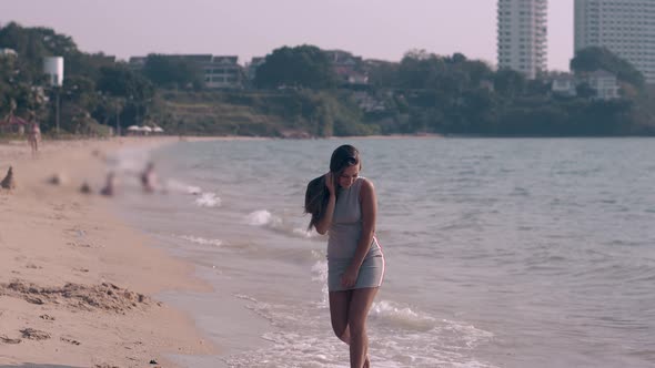 Pretty Long Haired Brunette in Gray Dress Walks Barefoot alt