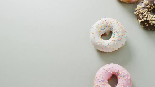 Video of donuts with icing on white background alt