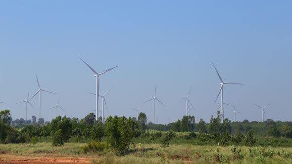 4k timelapse of Wind turbine producing alternative energy with blue sky alt