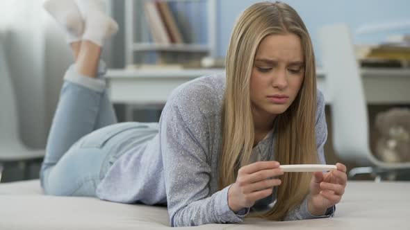 Two Strips on Pregnancy Test, Teenage Girl Finds Out About Having Baby, Fear alt