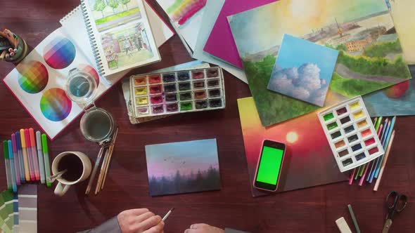 Artist Painting Landscape with Watercolors and Brush Top View alt