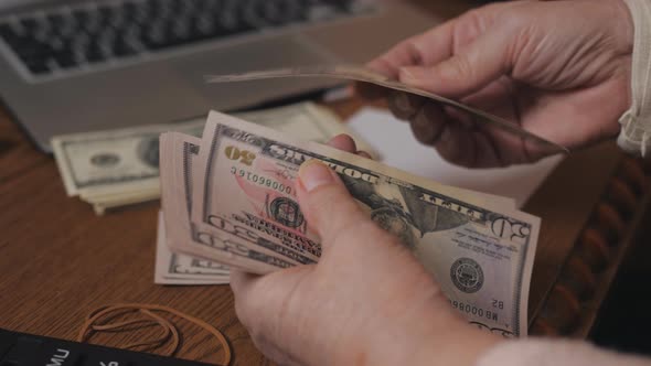 Detail of Old Person Hands with Dollars Counting Money