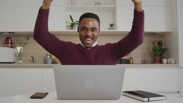 African American 20s Man Reads Good News and Celebrates an Achievement of a Milestone alt