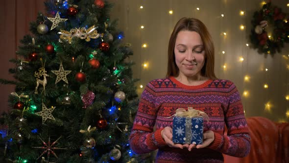 Young Woman Giving a Present Gift alt