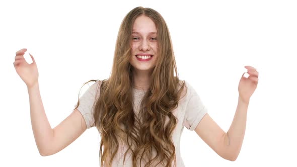 Portrait of Gorgeous Young Woman 17y Waving Head with Floating Brown Hair and Smile in Slow Motion alt