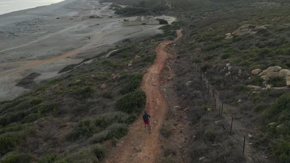 Biking on the coastline of Spain, near Gibraltar. Drone shot 4k cinematic alt