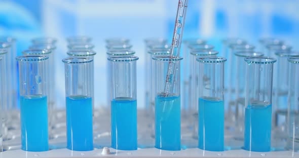 Lab Assistant Adding Green Liquid in Test Tube, Monitoring Chemical Reaction. Technician Carefully alt
