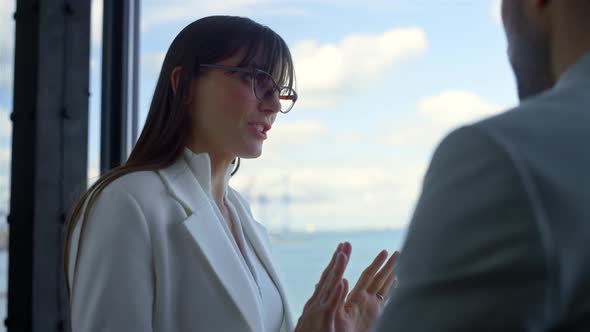 Closeup Colleagues Discussing Project at Panorama Window alt