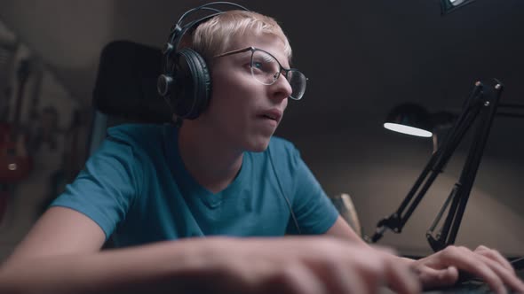 Caucasian Young Teen Guy Plays Games On Computer And Streams The Games Live alt