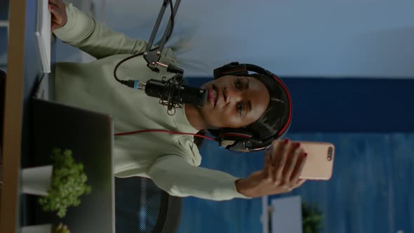 Vertical Video African Content Creator Taking Photo with Smartphone for Fans alt