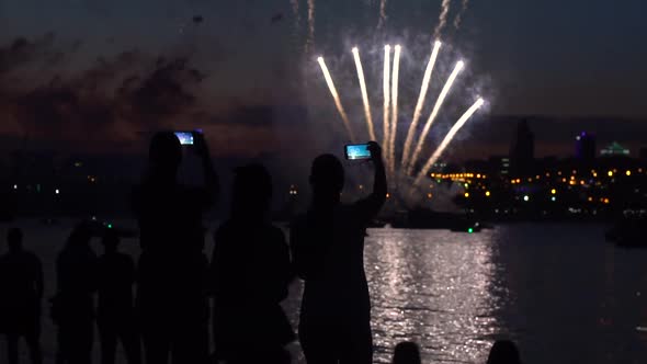 A Group of People During a Firework Near a River alt