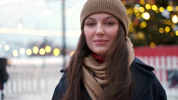 Pretty Woman Stands on the City Square Among Christmas Decorations alt