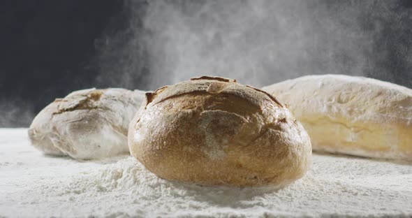 Bakery and Cooking Concept. Fresh Bread with a Splash Falls Into Flour alt