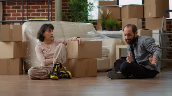 Man and Woman Disapproving with Each Other After Home Relocation alt