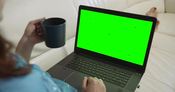 Woman with Laptop Chromakey on Sofa