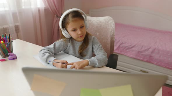 Schoolgirl Girl Studies Online On Laptop At Home