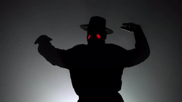 Funny Meme Footage of Comic Man in Plague Doctor Costume with Crow-like Mask Dancing with Hands alt