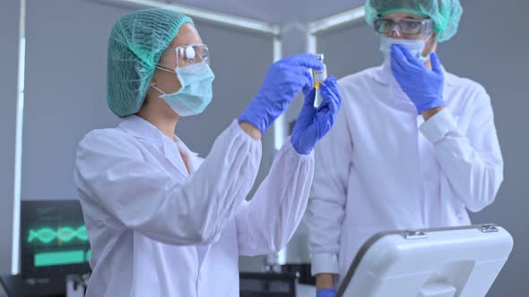 The Coronavirus vaccine researched by pharmaceutical bio research and development scientist team. alt