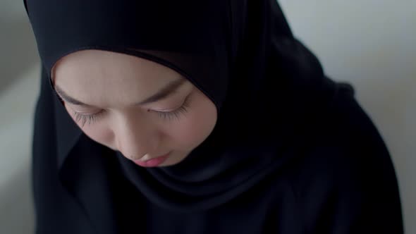Headshot portrait beautiful Muslim female wearing traditional clothing white background