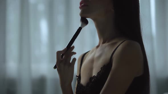 Beautiful Female Seductively Brushes Skin with Cosmetics Tool, Flirting Gestures alt