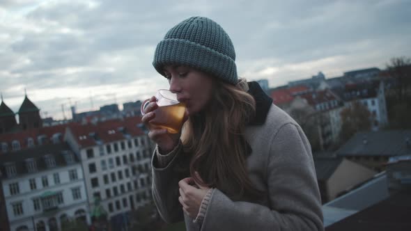 Woman Looking To Camera Before Sipping Hot Drink alt