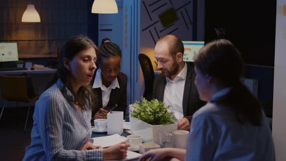Multi Ethnic Entrepreneurs Sitting at Conference Table Overworking at Company Solution Presentation alt
