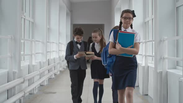 Schoolchildren Walking Along School Hallway alt