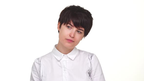 Thoughtful Young Woman Calmly Looking Around Smiling at Camera Isolated Over White Background in alt