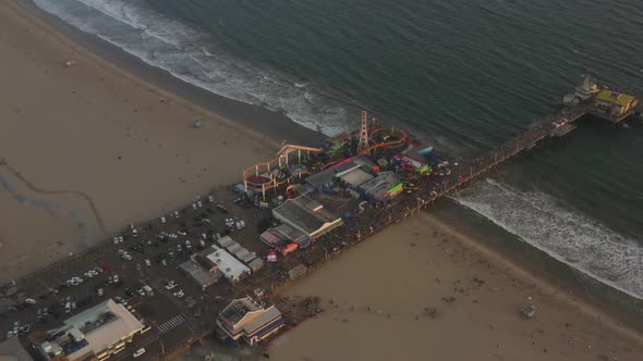 AERIAL: Circling Santa Monica Pier, Los Angeles From Above at Beautiful Sunset with Tourists alt